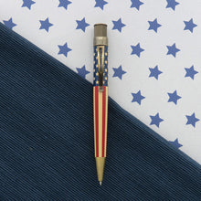 Load image into Gallery viewer, Front view of the rollerball pen. Placed on a textured blue background split by a white background with stars.