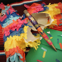 Load image into Gallery viewer, Side view of the pen arranged with with a broken piñata.