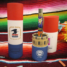 Load image into Gallery viewer, Side view of the pen arranged with two gift tubes on a vibrant background.