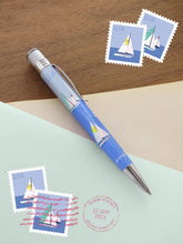 Load image into Gallery viewer, Side view of the pen on a blue and brown background with postage stamps