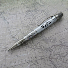 Load image into Gallery viewer, Side view of the The Retro 51 Spirit of St. Louis Rollerball Pen, laid on a print of a map.