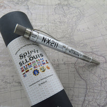 Load image into Gallery viewer, Side view of the The Retro 51 Spirit of St. Louis Rollerball Pen leaning on its matching gift tube. The pen's barrel is a light gray/white