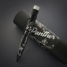 Load image into Gallery viewer, The black mechanical pencil with vintage panther tattoo graphics leaning on the gift packaging.