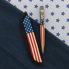Load image into Gallery viewer, Front view of the rollerball pen and the matching Rickshaw sleeve. Laid on a textured blue background split by a white background with stars.