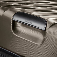 Load image into Gallery viewer, Close up to the bronze hard shell's bottom panel. It features a grab handle.