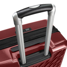 Load image into Gallery viewer, Angled top panel view of the red suitcase with the handle extended.