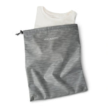 Load image into Gallery viewer, Close up to the laundry bag with a white shirt folded inside.