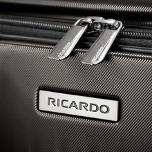 Load image into Gallery viewer, Close up to the zipper pulls and the Ricardo logo badge on the front panel.