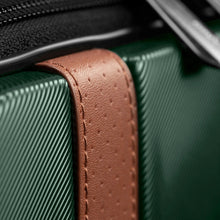 Load image into Gallery viewer, Close up to the tan leather straps attached to the green suitcase.