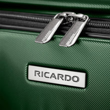 Load image into Gallery viewer, Close up to two zipper pulls, and the Ricardo logo badge on the front panel.