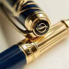 Load image into Gallery viewer, Close Up to the pen's grip section, which has an S.T. Dupont engraving, and the top of the cap, which has the cursive letter D.