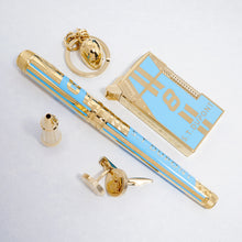 Load image into Gallery viewer, The pen arranged with the rollerball pen attachment, cufflinks, lighter, and key chain.