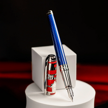 Load image into Gallery viewer, The fountain pen with the cap set next to it on a black, red, and white display.