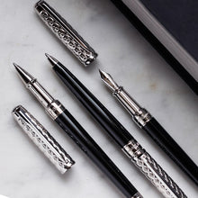 Load image into Gallery viewer, A collection of S.T. Dupont Eternity Fire X Art of Writing Pens with chrome accents, displayed on a marble surface.