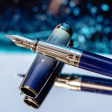 Load image into Gallery viewer, Close up to the fountain pen grip section resting on the cap.