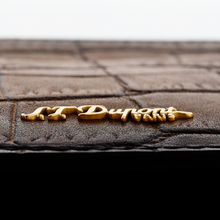 Load image into Gallery viewer, Angled close up to the S.T. Dupont logo on the front panel.