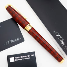 Load image into Gallery viewer, The capped fountain pen, displayed diagonally on a white surface alongside its black branded documentation and cards.