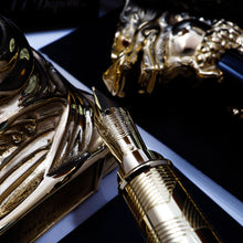 Load image into Gallery viewer, Close up to the fountain pen nib with the cap, stand and documents.