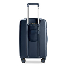 Load image into Gallery viewer, Briggs & Riley Sympatico Essential Carry-On Spinner - Navy
Back Panel View showing Power Pocket™ on the back of the bag allows for a pass-through USB cord for easy, on-the-go charging.
Dimensions: 22 x 14 x 9-11.25 in / 55.9 x 35.6 x 22.9-28.6 cm