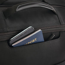 Load image into Gallery viewer, Close up to the front panel's pocket with a phone, passport and pen tucked in.
