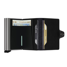 Load image into Gallery viewer, The original black Twinwallet extended, with credit cards and bills organized in the compartments.