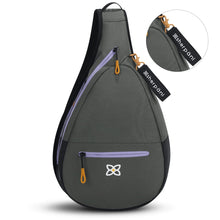 Load image into Gallery viewer, Front panel view of the sling bag with a close up to the black tag featuring the sherpani logo.
