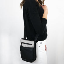 Load image into Gallery viewer, A model carrying the crossbody bag.