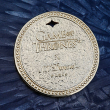 Load image into Gallery viewer, Front of the Coin featuring the Game of Thrones logo and the S.T. Dupont logo.