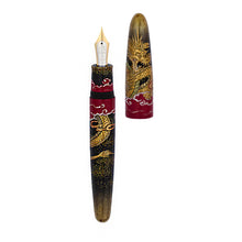 Load image into Gallery viewer, Decorative fountain pen with a golden dragon on red clouds, a black background and gold dust. The cap is set to the side.