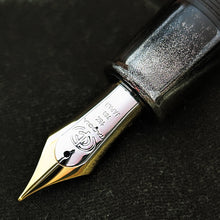 Load image into Gallery viewer, Close up to the fountain pen nib with engravings: The Taccia logo, 18K 750 JAPAN