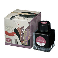 Load image into Gallery viewer, Taccia Utamaro Ume ink bottle and packaging with Japanese woodblock print designs on a white background. The ink is plum colored.