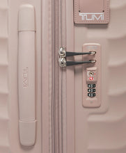 Load image into Gallery viewer, Close up to the side panel featuring a grab handle, a TSA approved three-digit combination lock, and a tag for contact information.