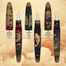 Load image into Gallery viewer, A set of three Taccia Empress fountain pens with different designs, one with a dragona, one with a koi fish, and another with fireflies and a pond scene, featured against a backdrop with clouds and a red textured background.