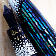 Load image into Gallery viewer, Close up to the hand-painted edition number, and the abalone with quail egg shells on the cap.