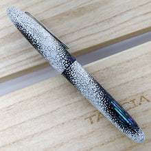 Load image into Gallery viewer, Side view of the fountain pen on top of the presentation box and lid