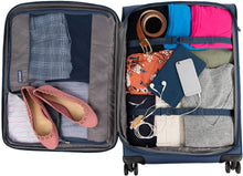 Load image into Gallery viewer, Interior view of the blue suitcase filed with clothes and travel accessories. A set of adjustable straps hold the contents in the main compartment.