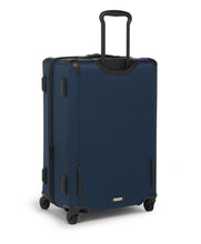 Load image into Gallery viewer, Angled back panel view of the blue suitcase.