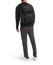Load image into Gallery viewer, A young man carrying the backpack on a white background.