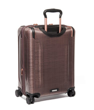 Load image into Gallery viewer, Angled back panel view of the blush pink suitcase.