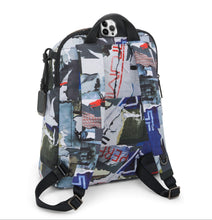 Load image into Gallery viewer, Angled back panel view of the backpack. A cellphone peeks from the pocket under the top grab handle.