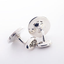 Load image into Gallery viewer, Angled views of the two cufflinks. The end part which keeps the cuff link in place features an engraving of the URSO logo.