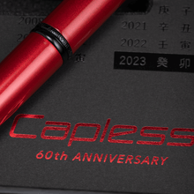 Load image into Gallery viewer, Close up to the pen in the presentation box. The black rings on the pen have an engraving that says "ANNIVERSARY"