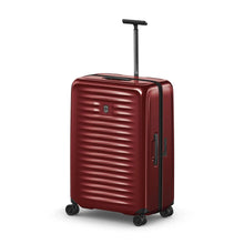 Load image into Gallery viewer, Angled front view of the red hard side suitcase with the telescopic handle extended.