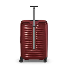 Load image into Gallery viewer, Back panel view of the red hard side suitcase with the telescopic handle extended.