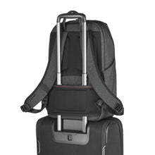 Load image into Gallery viewer, The backpack shown with the attachment feature on the back panel passed through the telescopic handle of a suitcase.