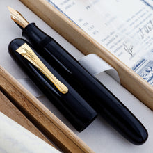 Load image into Gallery viewer, Close-up of the Visconti Black urushi Fountain Pen in its wooden box with the included documents.
