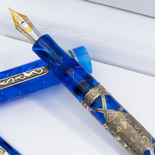 Load image into Gallery viewer, The fountain pen resting on top of the cap.