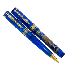 Load image into Gallery viewer, The Visconti Empire ballpoint and Fountain Pen on a white background. They are both translucent royal blue with gold vermeil accents.