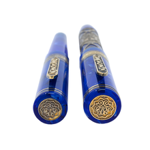 Load image into Gallery viewer, Angled view of cap tops. Each has a medal with a decoration.