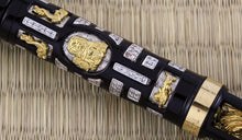 Load image into Gallery viewer, Close up to a gold vermeil featuring a lion-dog design.